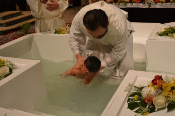 During the Pentecost Vigil at St. James Cathedral-Basilica on Saturday, May 19, Father Julio Cesar Sanchez Malagon baptized six children.