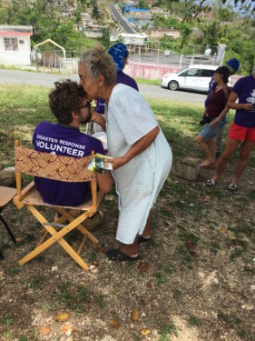 Leaning over one of the seated volunteers, abuela Ramos gently places a soft ‘thank you’ kiss on his head.