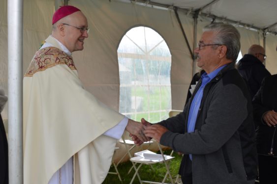 Bishop James Massa greets attendees at the Memorial Day Field Mass at St. Mary Star of the Sea Cemetery in Lawrence, L.I.