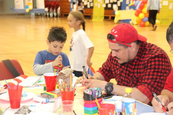 After Mass, the children and their families were invited to the parish center for a party featuring pizza, children’s art work on display and art and craft stations.