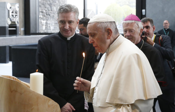 Pope Francis finishes lighting a candle as he visits the Chapel of the Apparitions at the Knock Shrine in Knock, Ireland, Aug. 26. (CNS photo/Paul Haring) 