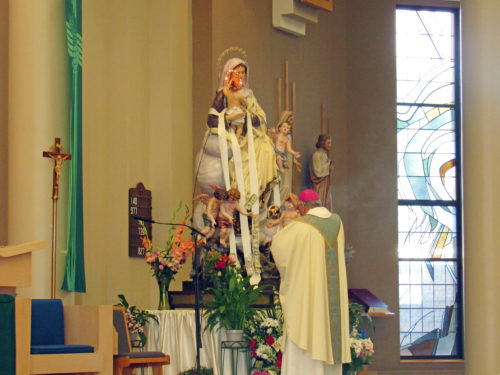  Bishop Nicholas DiMarzio joined the parish of St. Bernard, Mill Basin, to honor Our Lady of Mount Carmel, July 29. Following a midday Mass, the bishop led a street procession with the statue of Our Lady. (Photos: Isabella Wagner)