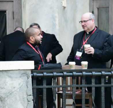 Father Henry Torres of Brooklyn and Auxiliary Bishop Richard G. Henning of Rockville Centre during a coffee break.