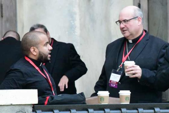 L.I. Auxiliary Bishop Richard G. Henning of the Rockville Centre Diocese chats with Father Henry Torres of the Brooklyn Diocese