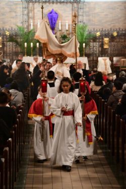 At Holy Child Jesus Church, Richmond Hill, the Blessed Sacrament is carried to the Altar of Repose at the end of Holy Thursday’s Mass of the Lord’s Supper. (Photo Jorge Dominguez)