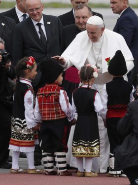 Pope Francis greets children in traditional dress as he arrives at the airport in Sofia. (Photos Catholic News Service/ Paul Harring)