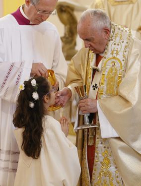 Pope Francis gives first Communion to a child during Mass at the Church of the Sacred Heart in Rakovski, Bulgaria, May 6. 