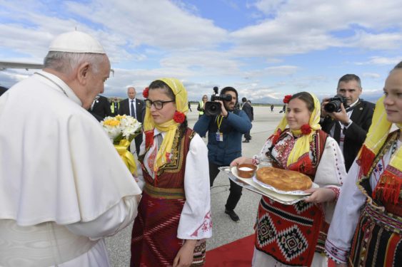 Pope Francis accepts gifts from women in traditional dress as he arrives at the international airport. (Photo Catholic News Service/ Vatican Media)