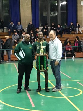 Knights senior point guard Tyler Chapman, center, was named tournament MVP. He’s pictured with St. Thomas Aquinas pastor Father Dwayne Davis, left, and tournament director Guy DeFonzo, right. (Photo courtesy St. Thomas Aquinas Sports Association)